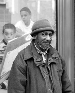 street portrait of a homeless man standing in from of the harold washington library in chicago. Quest for dirtman street photographs.